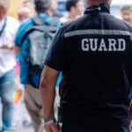 closeup security guard man in public area standing secure people or place outdoor.