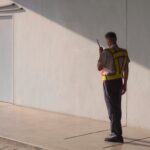 security guard holding a walkie talkie and waling